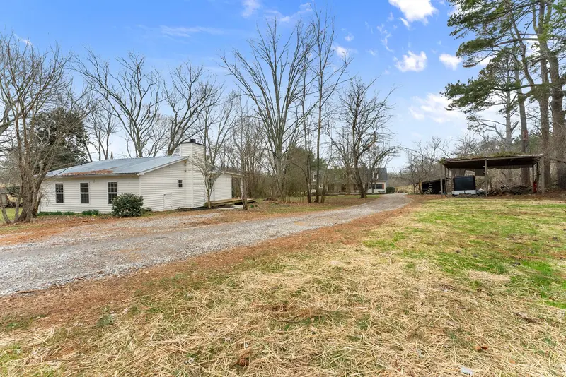 Cottage with driveway and pole barn